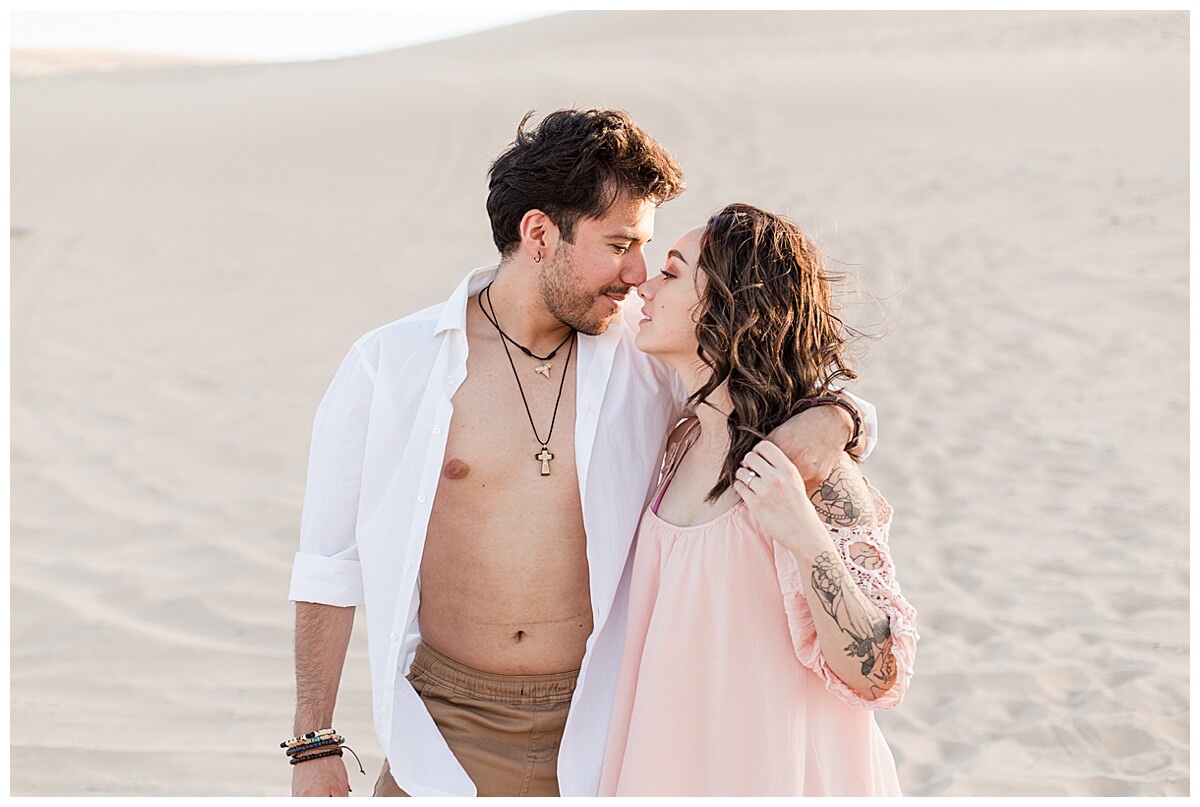 Couple kissing at Nellis sand dunes